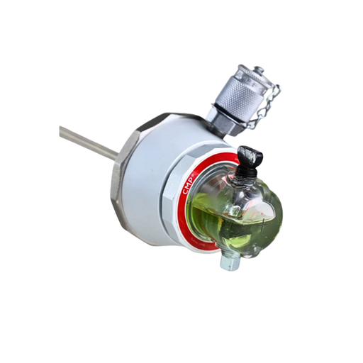 A metal industrial flow meter or sensor with a clear glass globe containing green liquid, a red ring, and a silver threaded connector on a plain white background.